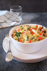 Italian pasta penne with tuna, bell pepper and capers. Warm salad