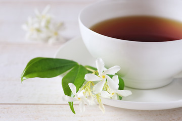 Fototapeta na wymiar Jasmine tea in a white bone china cup on white background