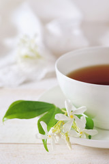 Obraz na płótnie Canvas Jasmine tea in a white bone china cup on white background