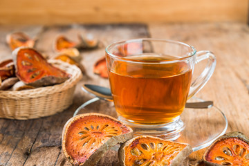 Bael tea juice on wooden table , healthy drink