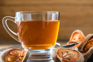 Bael tea juice on wooden table , healthy drink