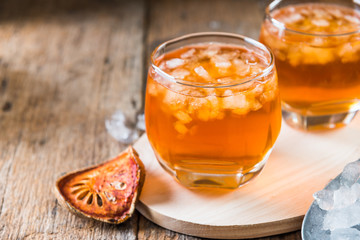 Bael juice ice tea on wooden table , healthy drink