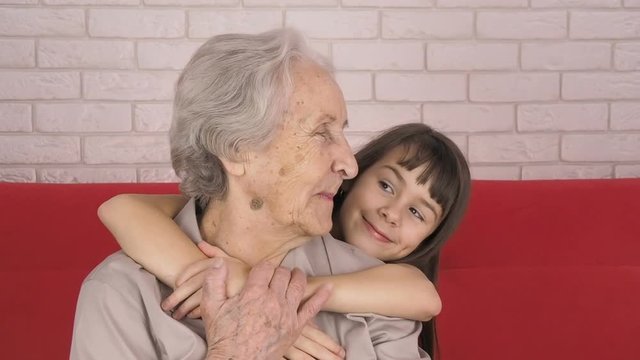 Grandmother with granddaughter. A child is hugging her grandmother.