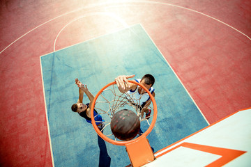High angle view of basketball player dunking basketball in hoop