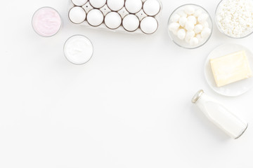 Natural farm products. Milk, cottage, eggs, cheese, yougurt on white background top view copy space. Monochrome