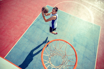 High angle view of basketball player dunking basketball in hoop