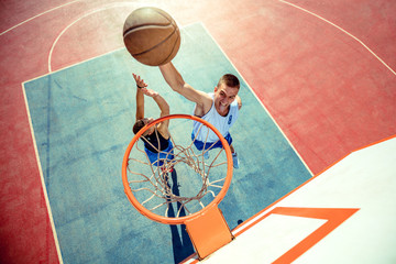 High angle view of basketball player dunking basketball in hoop