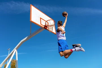 Fotobehang Young Basketball street player making slam dunk © FS-Stock