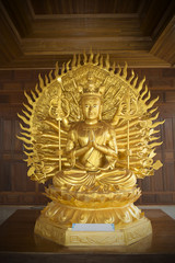 Golden Kuan Yin Thousand Hands statue in temple.