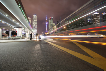 Fototapeta na wymiar the light trails on the modern building background in shanghai china