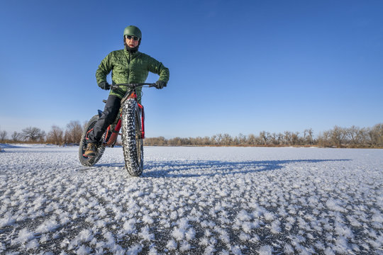 fat bike cyclist on a frozen lake in winter