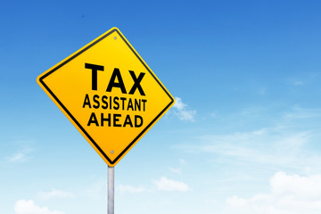 Tax assistant road sign shot over beautiful blue sky.