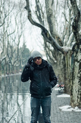 male tourist standing in Xiangyang park on middle Huaihai road, Shanghai