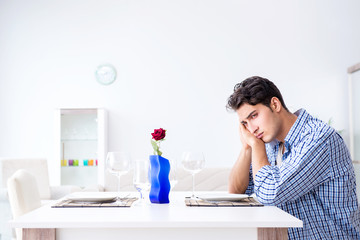 Man alone preparing for romantic date with his sweetheart
