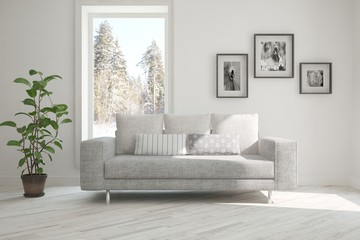 Fototapeta premium White room with sofa and winter landscape in window. Scandinavian interior design. 3D illustration