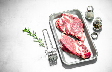 Fresh raw beef steak with spices.