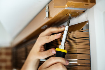 People installing window curtain