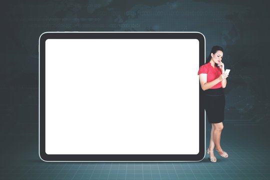 Beautiful entrepreneur standing with blank tablet - Powered by Adobe