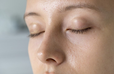 Closeup portrait of white woman eyes closed