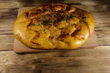 Pita bread on cutting board on wooden table