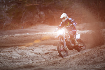 Motocross, enduro rider on dirt track. Extreme off-road race. Hard enduro motorbike. The forest...