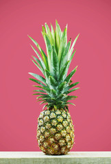 Pineapple with pink background.