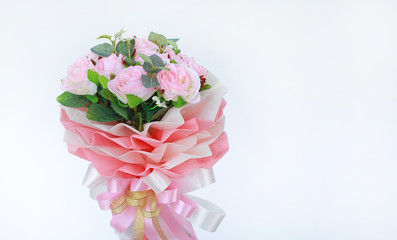 Artificial pink roses bouquet isolated on white background.