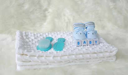 Collection of items for newborn babies on the bed.
