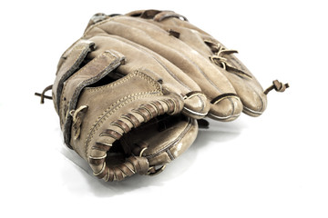 Old worn leather baseball glove on a white background. © bigjom