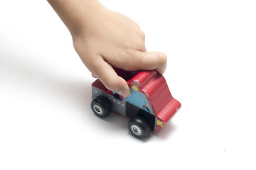Fototapeta premium child playing a wooden toy car.