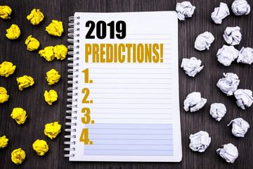 Conceptual hand writing text caption showing 2019 Predictions. Business concept for Forecast Predictive Written on notepad note notebook book wooden background with sticky folded yellow and white