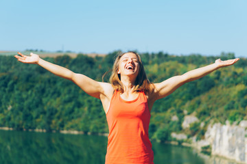 Young fitness woman exercising in park with mobile phone and earphones