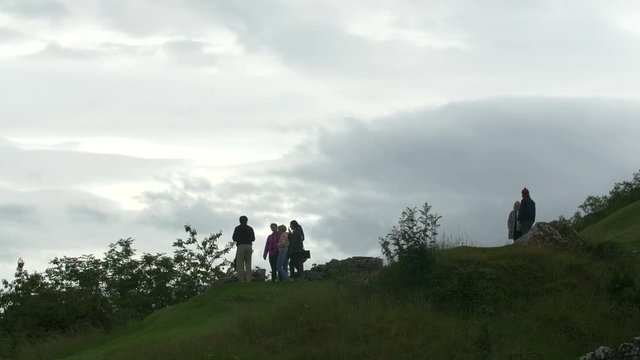 People on a hill taking pictures