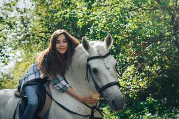 Foto op Canvas Girl teenager and white horse in a park in a summer © keleny