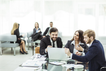 employees of the company work on laptop with information on the development of the company