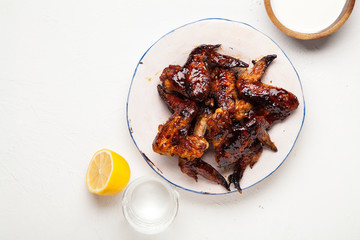 Chicken wings with two sauces on white background. Summer barbeque concept.