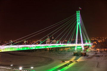 Bridge of lovers with night illumination. The city of Tyumen. Russia