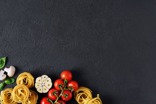 Ingredients for tagliatelle pasta on a dark background.