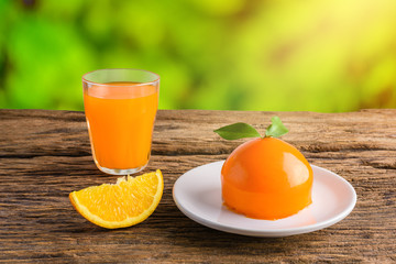 Orange cake and Glass of Fresh Orange Juice on grunge wooden table