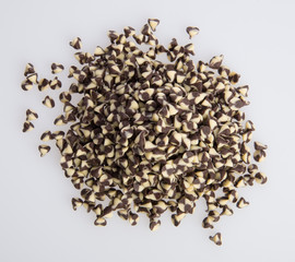 Chocolate chip morsels spread on a background.