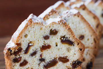 Homemade traditional chopped cupcake with raisins on the wooden background. Closeup, selective focus