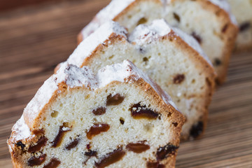 Homemade traditional chopped cupcake with raisins on the wooden background. Closeup, selective focus