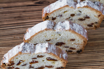 Homemade traditional chopped cupcake with raisins on the wooden background. Closeup, selective focus