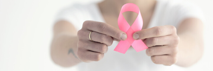 Person holding pink ribbon