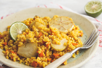 Curry bulgur with vegetables in white plate. Healthy vegan food concept.