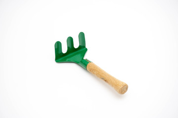 Gardening tools rake on white background