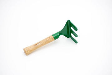 Gardening tools rake on white background