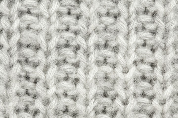 White-gray wool texture. Texture of wool. Knitting natural wool white-gray background.