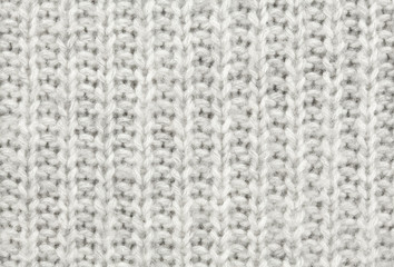 White-gray wool texture. Texture of wool. Knitting natural wool white-gray background.