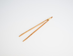 Tongs or Wooden tongs on a background.